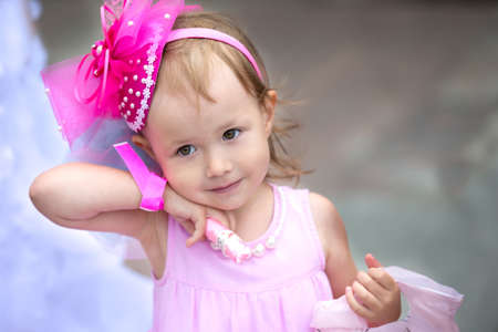Little girl in pink clothes with a bouquet.の写真素材