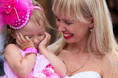Russia, Moscow, Izmaylovsky Park, August 27, 2017. International Photo Festival.Mom looks at her little daughter. Mom and beautiful girl.のeditorial素材