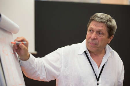 Belarus Minsk 06 August 2016 The Park of High Technologies. Competitions programmers.The teacher explains the task. Teacher's work. Elderly teacherのeditorial素材