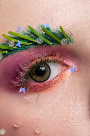Beautiful girl in a fabulous look with flower horns sits on a chair. Maleficent. Spring or summer...