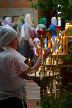 Belarus, the city of Gomil, April 8, 2018. City church. Orthodox Easter.Woman in a church by candlelightのeditorial素材
