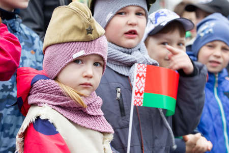 Belarus, the city of Gomel, May 9, 2019. Holiday Victory Day.Child in a military cap with a Belarusian flag.のeditorial素材