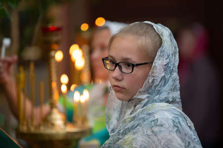 Belarus, the city of Gomil, April 8, 2018. City church. Orthodox Easter.Teenager girl in a headscarf...