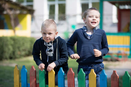 Belarus, the city of Gomil, April 26, 2019. Kindergarten on the street.Two little friends are playing. Kindergarten boys in the playgroundのeditorial素材