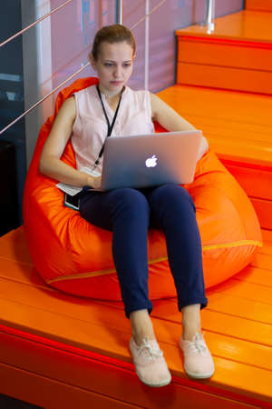 Belarus, Minsk city, August 06, 2017. Programmers Office. Vertical girl with a computer. IT specialist student.のeditorial素材