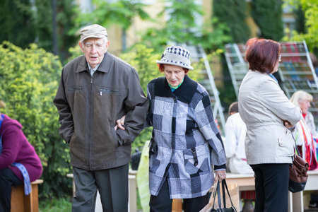 Belarus, the city of Gomil, May 25, 2018. City holiday. An elderly couple walks along the street....