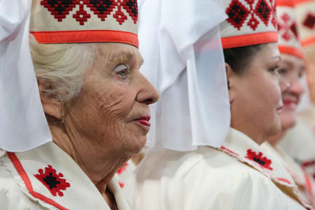 Belarus, the city of Gomil, November 12, 2018. House of retirees. Old Slavic women sing songs. Belarusian women in national hats.のeditorial素材