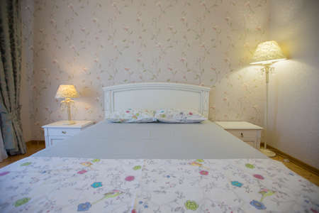 Interior with white bed and table lamp. Bedroom