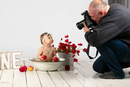 A photographer takes a picture of a child. The work of a child photographer.の写真素材