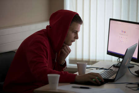 Belarus, Gimel, March 2, 2019. Business Center. Hackathon city. Teen in the hood at the computer