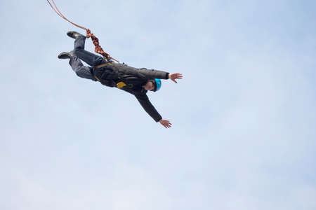 Belarus, Gomel, March 08, 2019. Jumping from the bridge to the rope.Ropejumping.A man jumps from a...