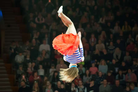 Belarus, Gomel, April 1, 2018. Gomel State Circus. Performance of the team of the Moscow circus Nikulin.A dangerous jump of the head of a circus gymnast without insurance against the backdrop of the spectatorsのeditorial素材