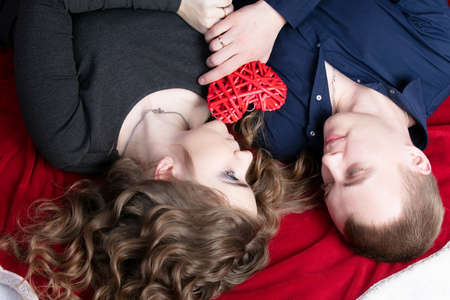Loving couple from top to bottom. Man and woman with a red heart. Beautiful young husband and...