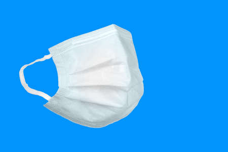 Medical white mask on a blue background. Corona virus protection concept. Respiratory medical...