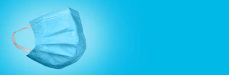 Banner surgical mask on a blue background. Corona virus protection concept. Respiratory medical...