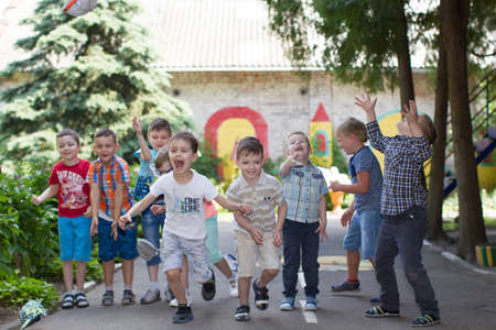 Belarus, Gomel, May 29, 2018. The kindergarten is central. Open Day.A group of children in a kindergarten on the street playing fun. Happy preschoolersのeditorial素材