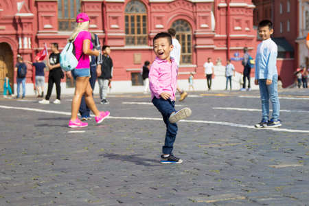 Russia, Moscow, July 29, 2018. The Red Square. Tourists on the Red Square. People in the center of Moscow. Chinese boy in Red Squareのeditorial素材