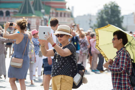 Russia, Moscow, July 29, 2018. The Red Square. Tourists on in Moscow. Woman taking selfie on Red Squareのeditorial素材
