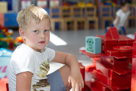 Belarus, Gomel, May 29, 2018. The kindergarten is central. Open Day.A boy in kindergarten plays in a wooden constructorのeditorial素材