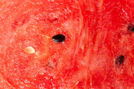 Texture of watermelon close-up. Red pulp of watermelon with seeds.