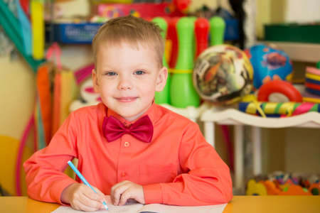Belarus, the city of Gomil, April 26, 2019. Open day in kindergarten.Child preschooler with book on class background. Boy schoolboy primary school. Portrait of a six year old childのeditorial素材