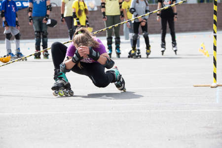 Belarus, Gomel, June 24, 2018. Central Park.Competition in roller sport.An athlete on roller skates rides under the barbellのeditorial素材