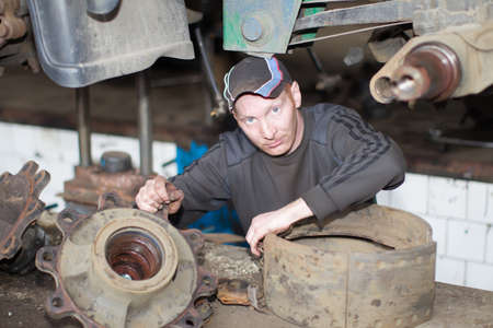 Belarus, Gomel, April 27, 2018. Automobile base. Work car mechanic makes a car.Car repairのeditorial素材