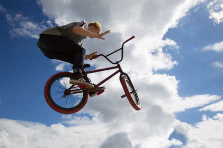 Belarus, Gomel, June 24, 2018. Central park. Extreme cycling.A man on an extreme bicycle against the sky. Leap into the skyのeditorial素材