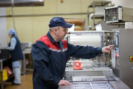 Belarus, the city of Gomel, on April 26, 2018. Meat plant. Working packer for packing machine