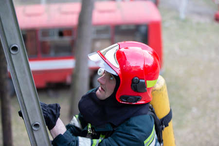 Firefighter climbs the stairs.