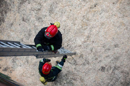 Firefighter climbs the stairs. Lifeguard training.の写真素材