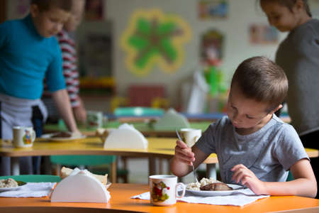 Boy child does not want to eat. Bad appetite. Eating in kindergartenの写真素材