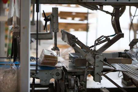 Industrial line for packaging of bakery products. Packing of bread at the factory. The machine for...