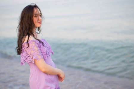 Young beautiful girl with flowing hair by the sea