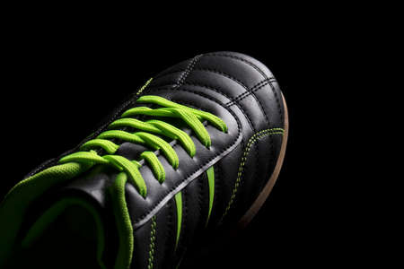 Fragment of a black sneaker closeup. Part of leather sports shoesの写真素材