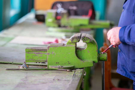 Working hands at the vise. Working locksmithの写真素材