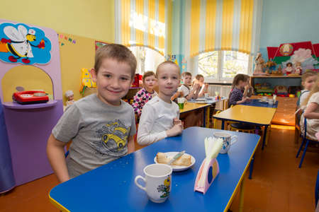 Belarus, the city of Gomel, April 25, 2019. An open day for visitors in kindergarten. Children eats in kindergarten.のeditorial素材