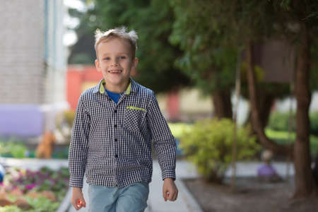 Belarus, the city of Gomel, April 25, 2019. Kindergarten open day. Happy child from kindergarten plays on the street.のeditorial素材