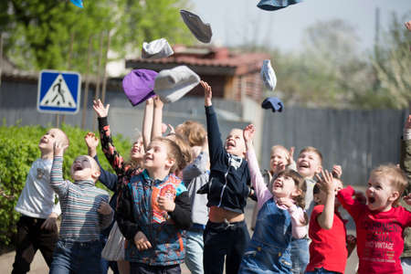 Belarus, the city of Gomil, May 30, 2019. Photosession in kindergarten. Children from kindergarten throw up their hats.のeditorial素材