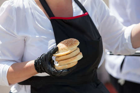 Hamburger buns in the hands of the chef.
