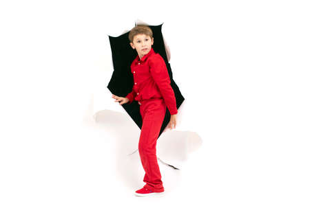 A child from a hole in paper. Cardboard show boyの写真素材