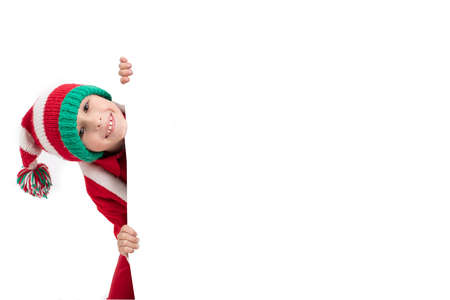 Boy Santa Claus peeks out of a billboard. Christmas holidays concept. Christmas childの写真素材