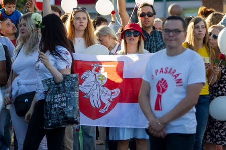 Belarus, the city of Gomel, August 14, 20120. Rally against the dictator Lukashenko. People with a red and white Belarusian flag at a rally.のeditorial素材