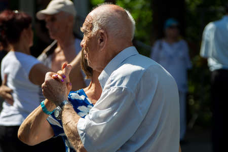 Russia, Moscow, July 29, 2018. Sokolniki park. An elderly couple dancing on the dance floor. Active pensioners.のeditorial素材