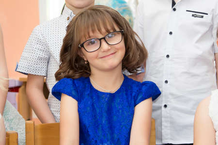 Belarus, the city of Gomil, May 30, 2019. Photosession in kindergarten. The face of a girl of elementary age with glasses.のeditorial素材