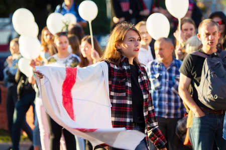 Belarus, the city of Gomel, August 14, 20120. People at the rally against the dictator Lukashenko. A woman with a red-white Belarusian flag at a rally.のeditorial素材