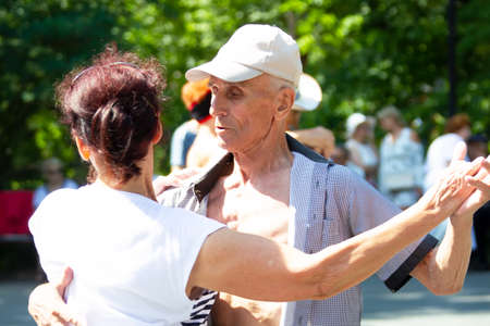 Russia, Moscow, July 29, 2018. Sokolniki park. An elderly couple dancing on the dance floor. Active pensioners.のeditorial素材