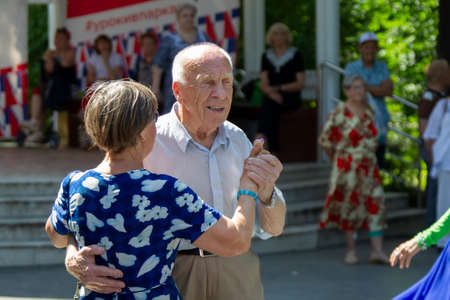 Russia, Moscow, July 29, 2018. Sokolniki park. An elderly couple dancing on the dance floor. Active pensioners.のeditorial素材