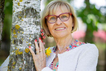 Belarus, the city of Gomel on July 31, 2019. The streets of the city. Portrait of a beautiful elderly woman in the park.のeditorial素材
