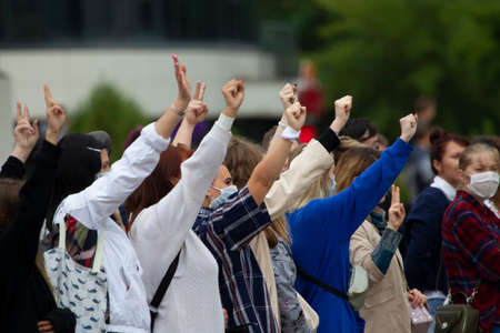 Belarus, Gomel, August 12, 2020. The streets of the city. Peoples protest against Lukashenka. Peaceful rally in Belarus against the dictator. People with raised hands at the protest.のeditorial素材